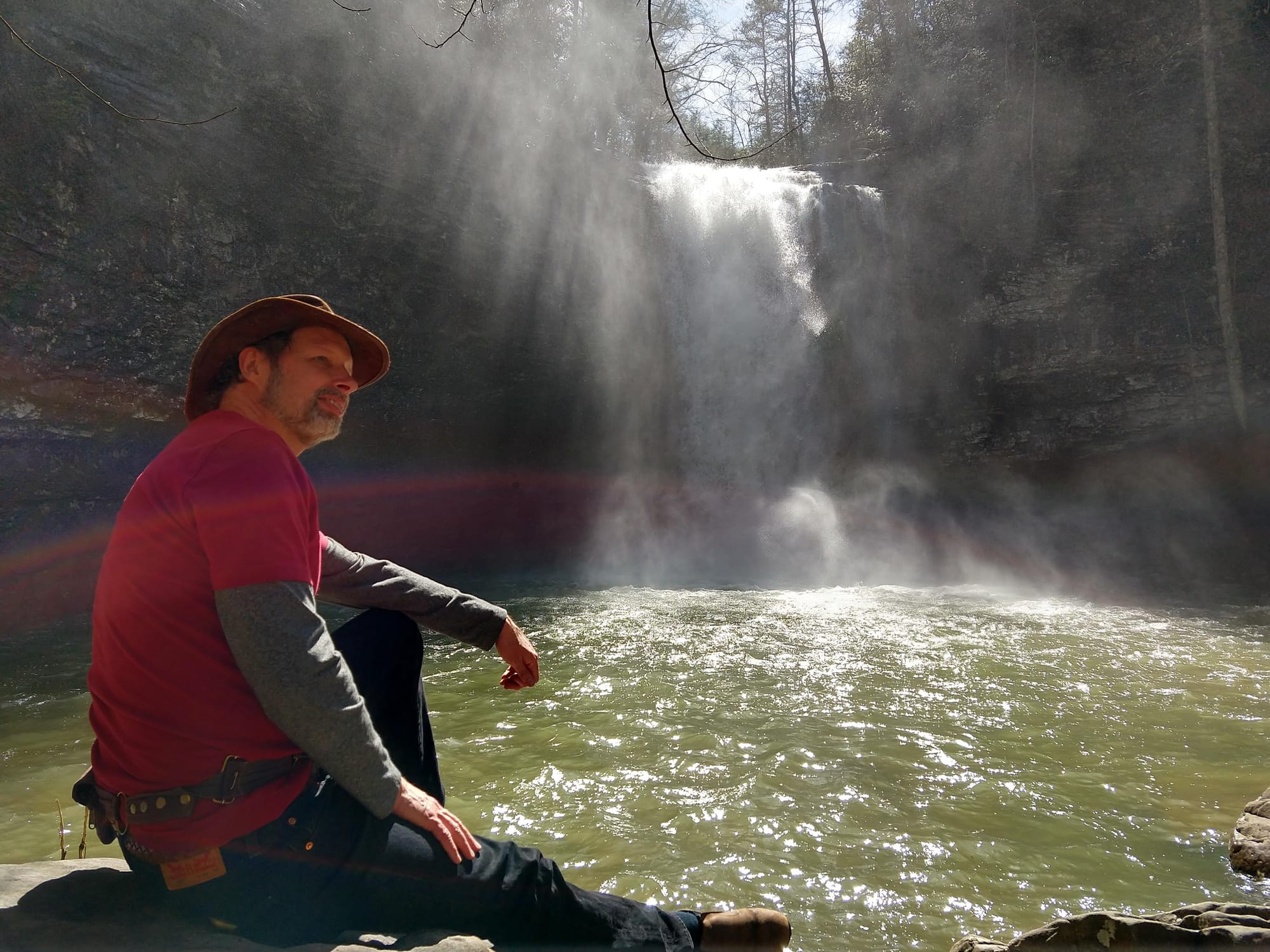 Mars sitting at a waterfall, present and at peace
